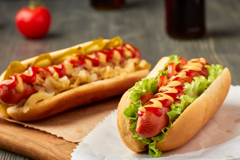Two juicy hot dogd with vegetables